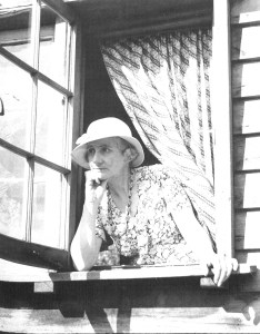 Katharine Prichard looking out the window of her writing cabin, ca. 1930s.